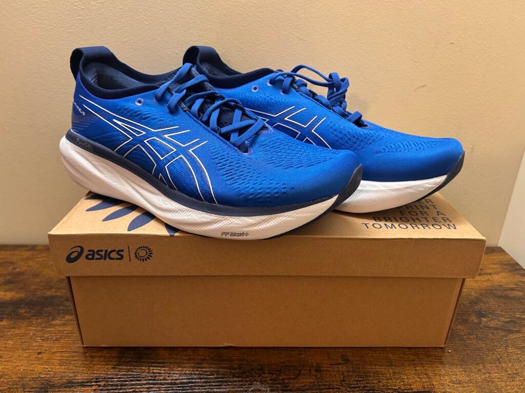 Royal Blue Asics Gel Nimbus 25 running shoes sitting on their shoe box