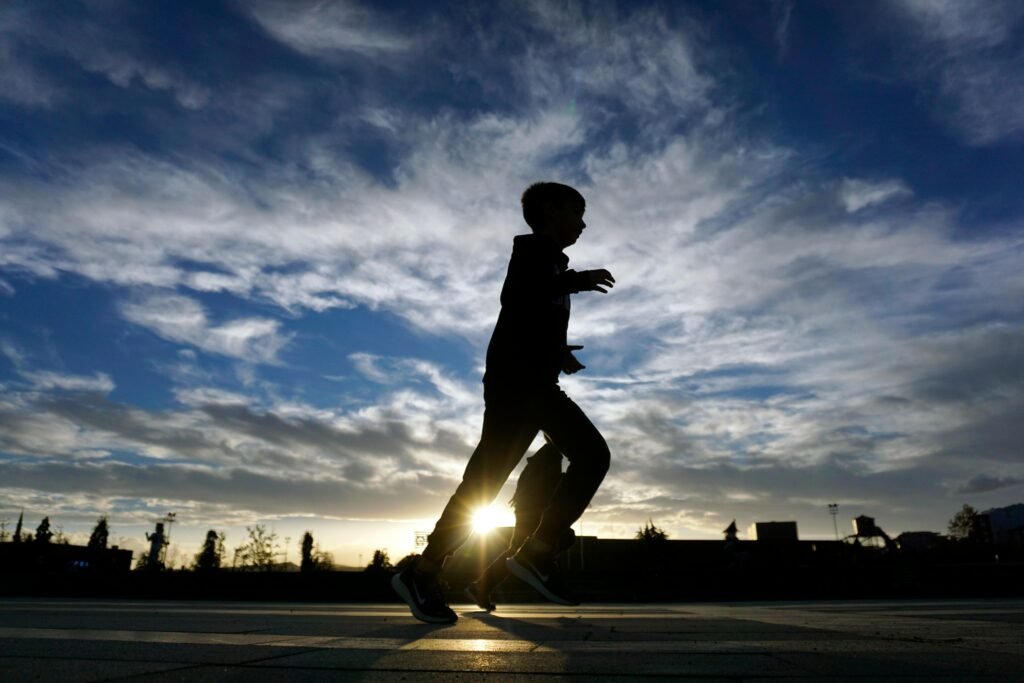 Silhouette running with sunrise background