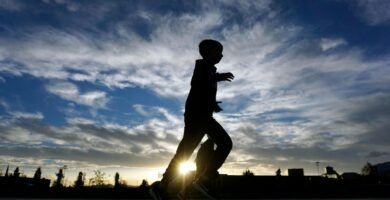 Silhouette running with sunrise background